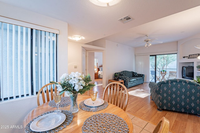 dining area featuring ceiling fan, wood finished floors, and visible vents