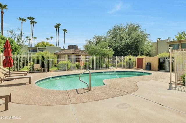 pool featuring fence and a patio