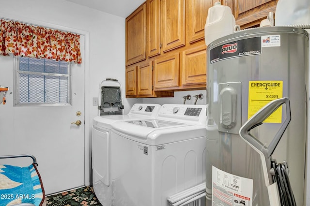 clothes washing area with cabinet space, washing machine and dryer, and water heater