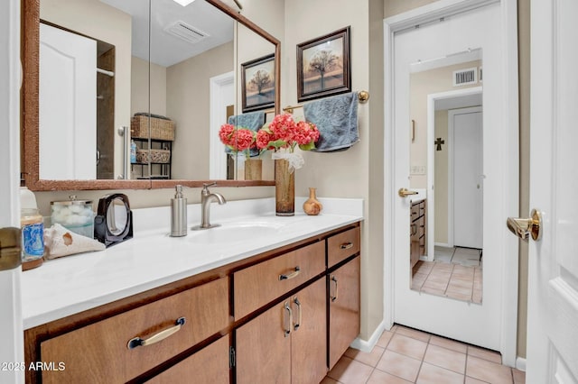 bathroom with a shower, visible vents, vanity, and tile patterned floors