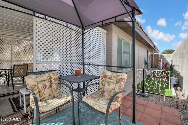 exterior space with a fenced backyard and a gazebo