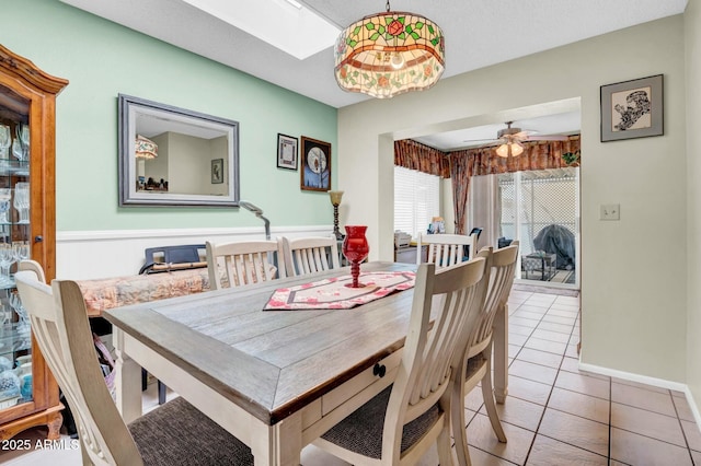 dining room with a ceiling fan and light tile patterned flooring