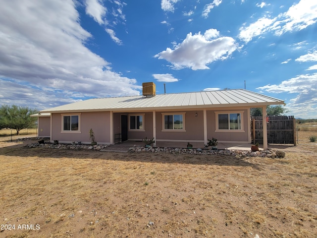 8075 E Bloomfield Rd, Hereford, AZ 85615 - rear view of house with metal roof, a patio area, stucco siding, and fence