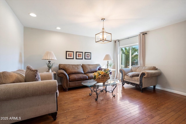 living area with a chandelier, recessed lighting, baseboards, and wood-type flooring