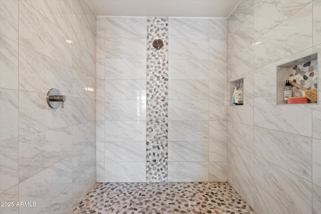 full bath with a tile shower