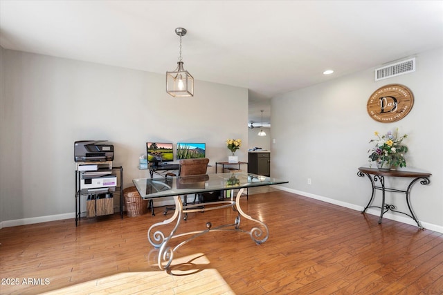 office area featuring baseboards, visible vents, and wood-type flooring