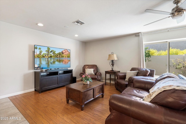 living room featuring light wood finished floors, visible vents, baseboards, recessed lighting, and a ceiling fan