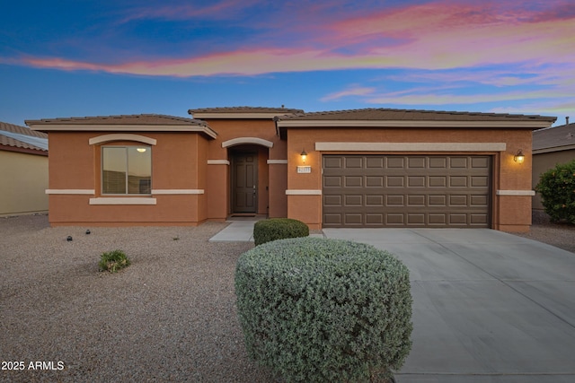 42335 W Waterfall Way, Maricopa, AZ 85138 - prairie-style home with an attached garage, driveway, a tiled roof, and stucco siding