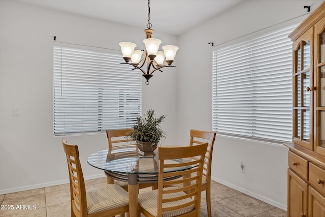 42335 W Waterfall Way, Maricopa, AZ 85138 - dining area featuring light tile patterned floors, baseboards, and an inviting chandelier