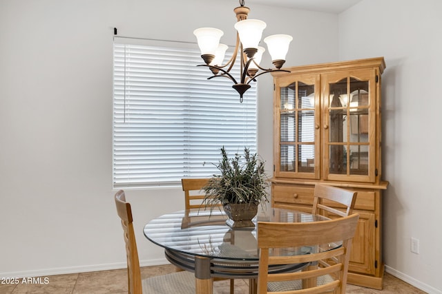 42335 W Waterfall Way, Maricopa, AZ 85138 - dining area featuring light tile patterned floors, baseboards, and an inviting chandelier