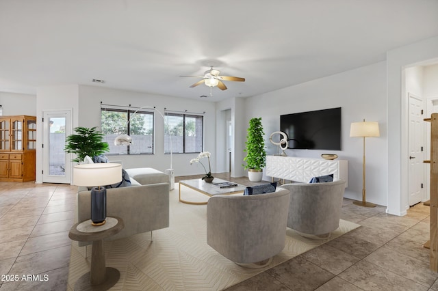 42335 W Waterfall Way, Maricopa, AZ 85138 - living area featuring light tile patterned floors, visible vents, baseboards, and ceiling fan