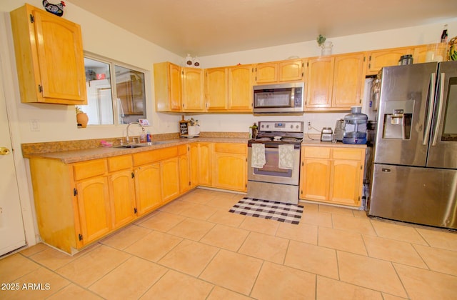 505 W 13th St, Casa Grande, AZ 85122 - kitchen with stainless steel appliances, a sink, light tile patterned floors, light countertops, and light brown cabinets