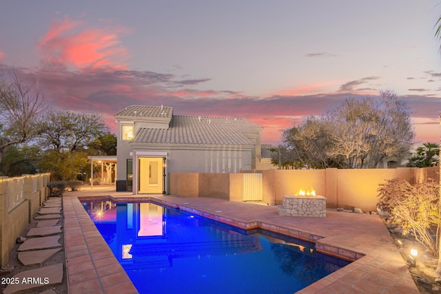 view of pool featuring a fenced in pool, an outdoor fire pit, a fenced backyard, and a patio