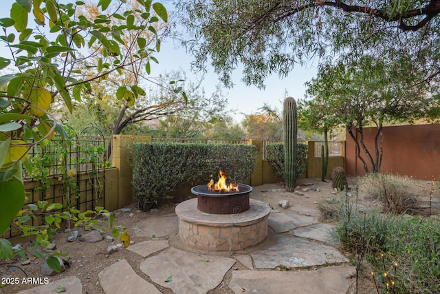 view of patio / terrace featuring a fenced backyard and a fire pit