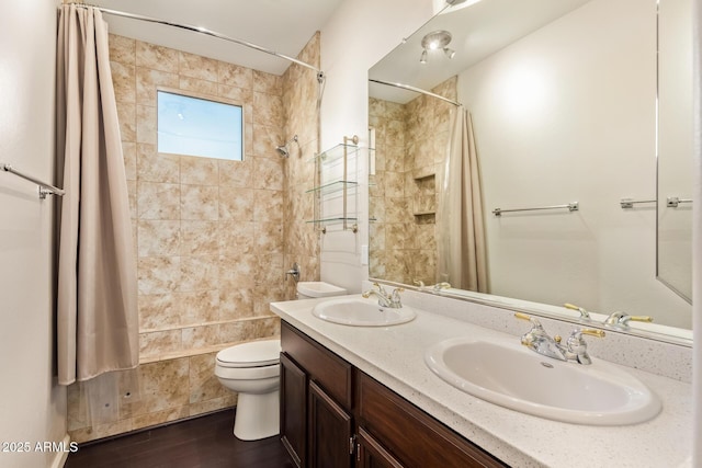 bathroom featuring toilet, shower / tub combo, double vanity, and a sink