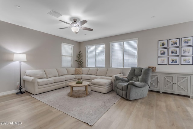 living room with ceiling fan and light hardwood / wood-style floors