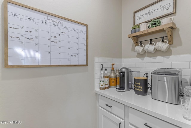 kitchen with decorative backsplash and white cabinetry