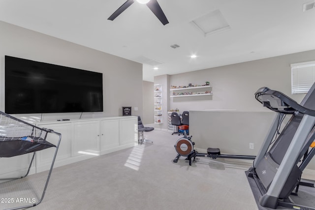 workout room with ceiling fan and light carpet