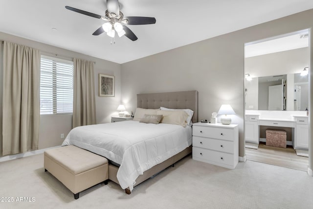 bedroom with light carpet, ceiling fan, and sink