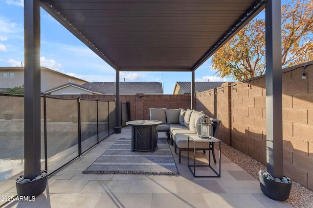 view of patio / terrace featuring an outdoor living space with a fire pit