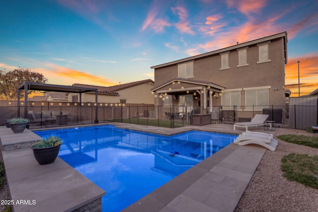 pool at dusk featuring a patio