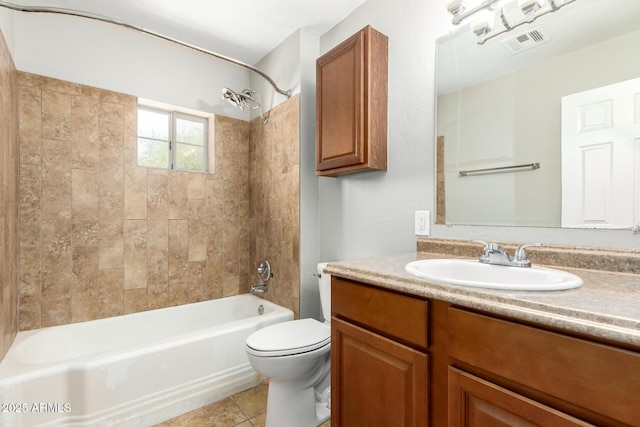 bathroom featuring vanity, tile patterned floors, toilet, visible vents, and bathtub / shower combination