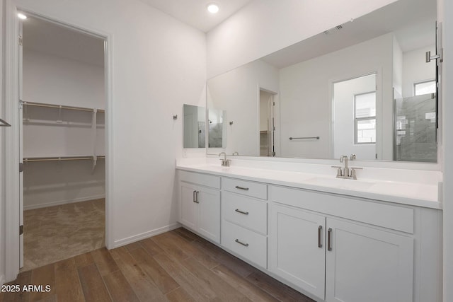 bathroom with vanity, a shower, and hardwood / wood-style floors