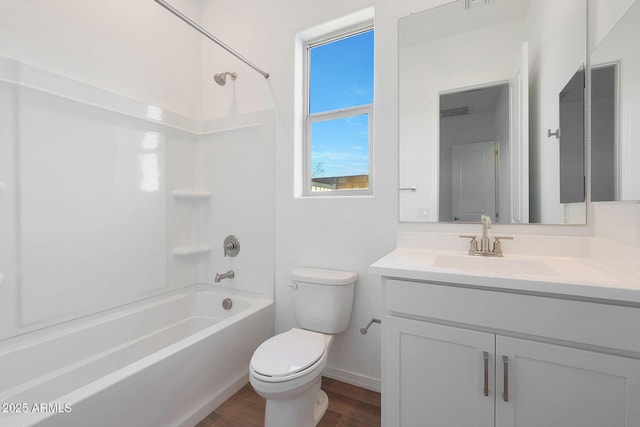 full bathroom featuring vanity, toilet, hardwood / wood-style floors, and shower / bathing tub combination