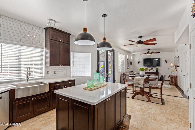 kitchen featuring backsplash, ceiling fan, pendant lighting, and a healthy amount of sunlight