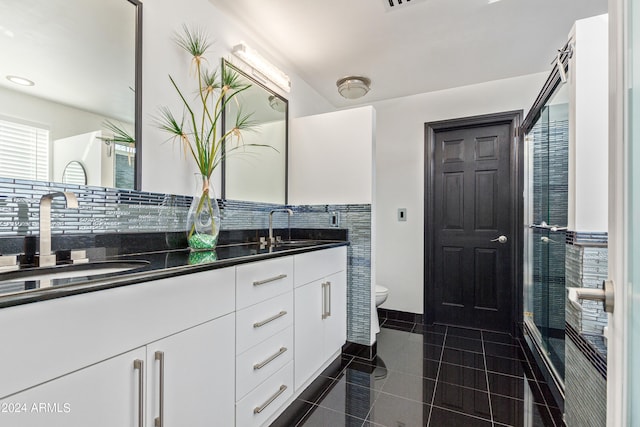 bathroom with vanity, toilet, and tile patterned floors