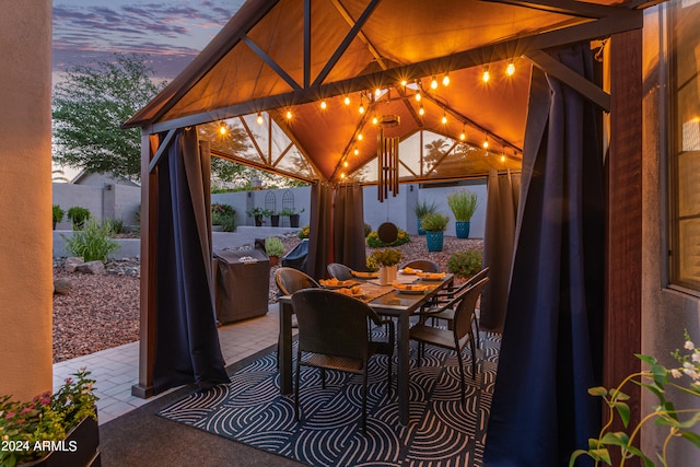 patio terrace at dusk featuring a gazebo