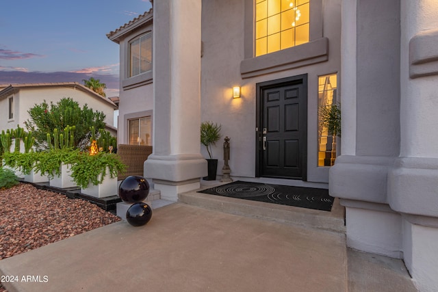 view of exterior entry at dusk