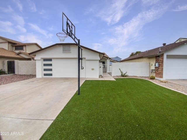 view of front facade featuring a gate, fence, driveway, and an attached garage