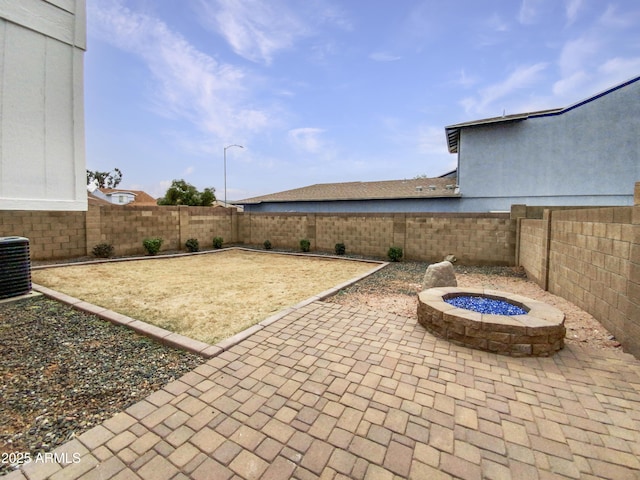 view of patio with an outdoor fire pit, a fenced backyard, and central AC unit