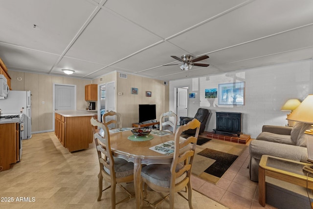 34381 S Vladimir St, Black Canyon City, AZ 85324 - dining room featuring a wood stove, a ceiling fan, and visible vents