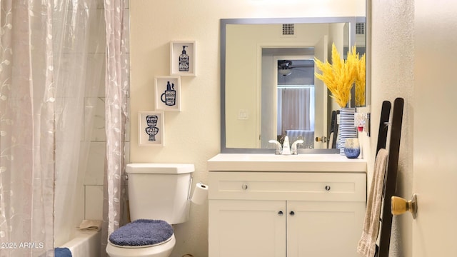 bathroom with visible vents, a textured wall, toilet, shower / tub combo with curtain, and vanity