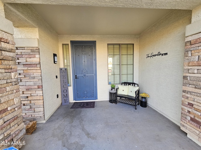 doorway to property with brick siding