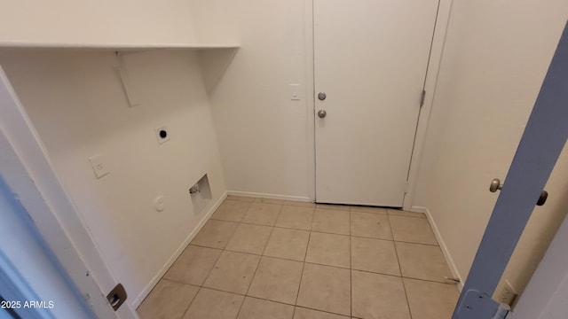 washroom featuring laundry area, baseboards, gas dryer hookup, electric dryer hookup, and light tile patterned flooring