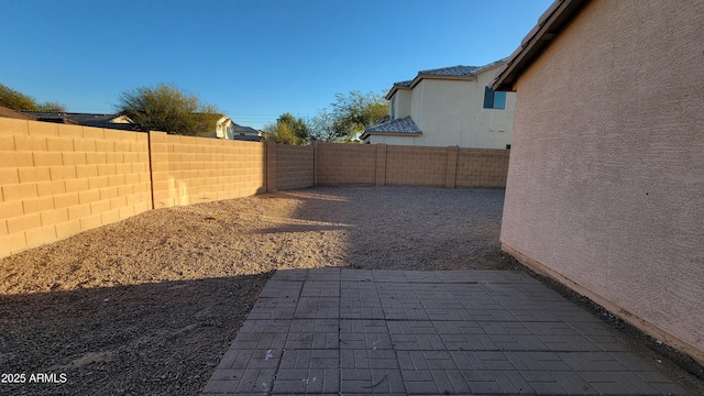 view of yard with a fenced backyard and a patio