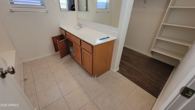 full bathroom with baseboards, vanity, and tile patterned floors