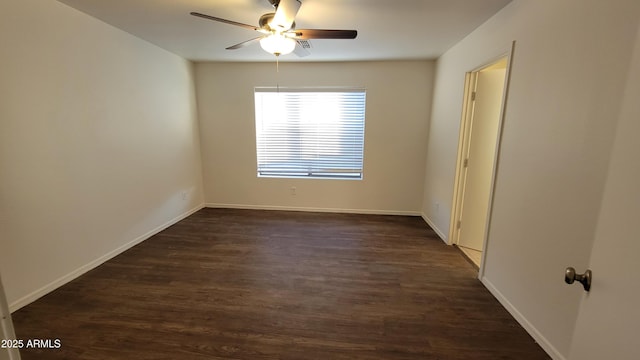 empty room featuring dark wood-type flooring, baseboards, and a ceiling fan