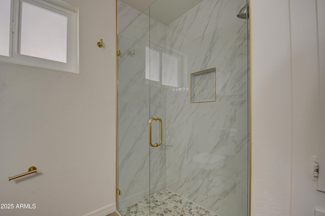 bathroom featuring a shower with shower door