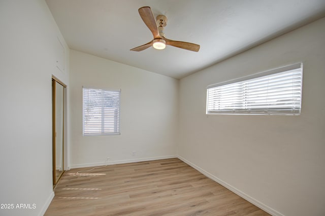 empty room featuring ceiling fan, light hardwood / wood-style flooring, and vaulted ceiling