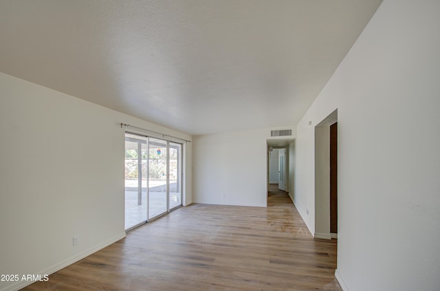 spare room with light wood-type flooring