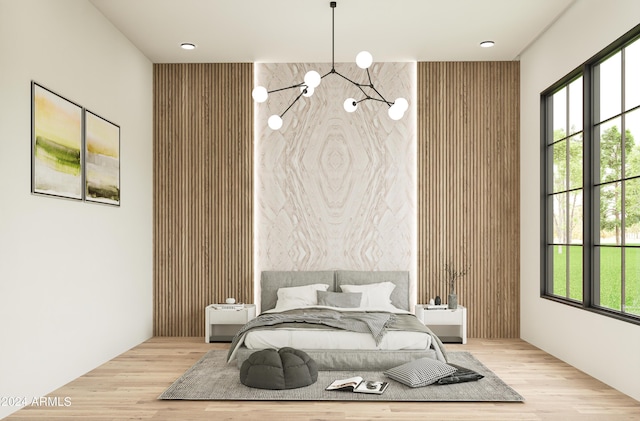 bedroom featuring an inviting chandelier and wood finished floors