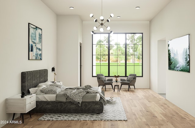 bedroom with a chandelier and wood finished floors