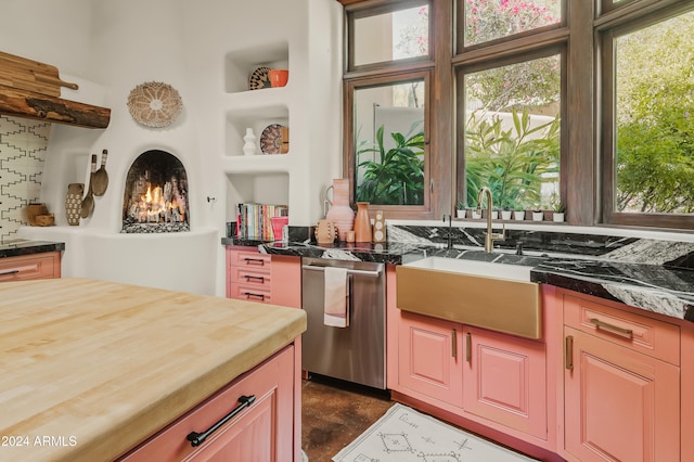 kitchen featuring sink, wood counters, and dishwasher