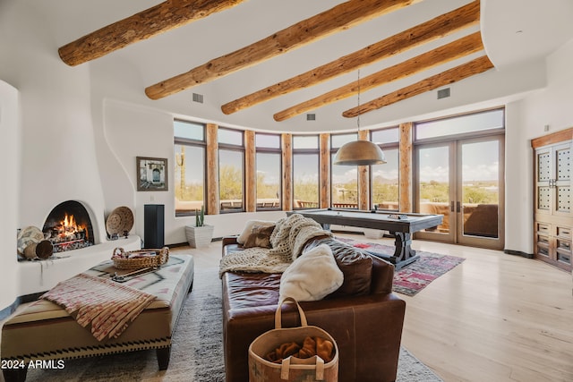 living room with pool table, light wood-type flooring, french doors, beam ceiling, and high vaulted ceiling