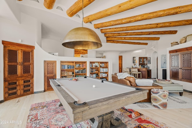 rec room with light hardwood / wood-style floors, beamed ceiling, billiards, and a high ceiling