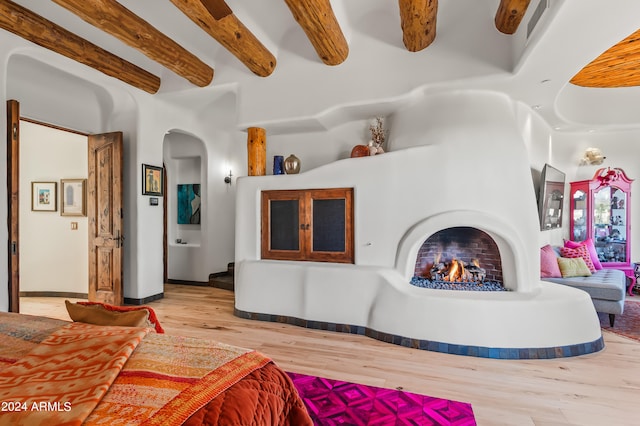 living room with beamed ceiling and light hardwood / wood-style flooring